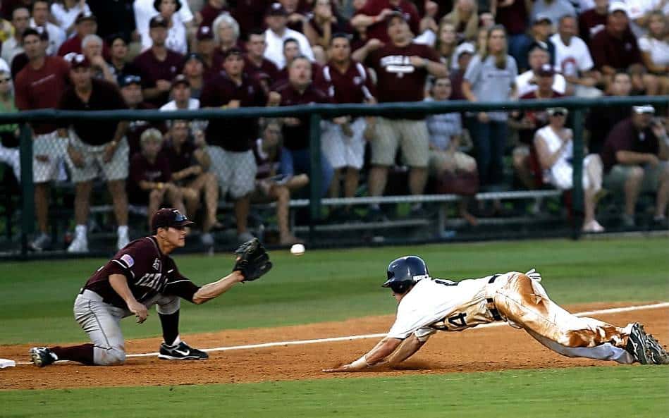 Runner in baseball dives into third base as ball reaches bases.