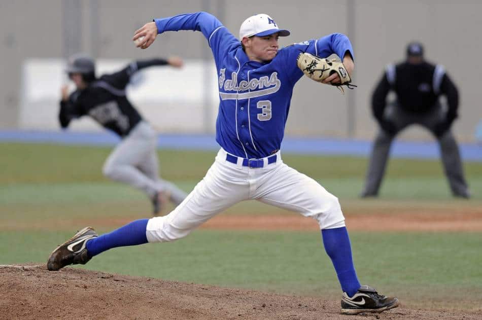 Runner on first base steals as pitcher throws home.