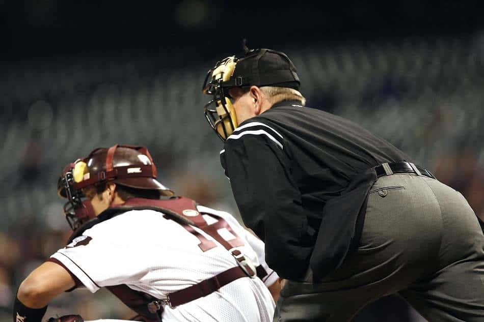 Baseball umpire sets up behind the catcher.