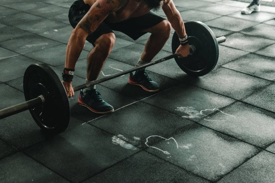 Man lifting weights in a gym.