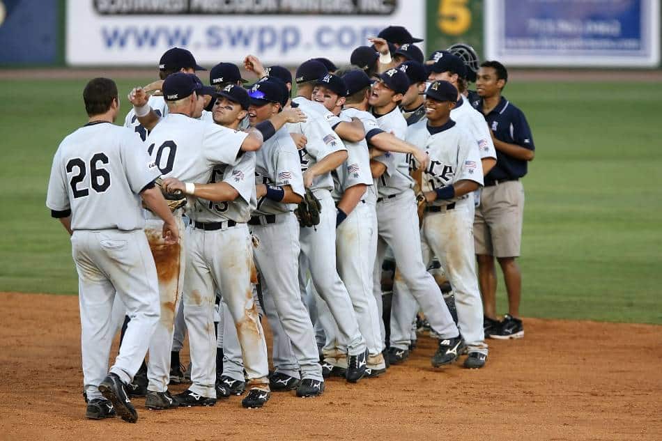 Baseball team celebrates after winning a game.