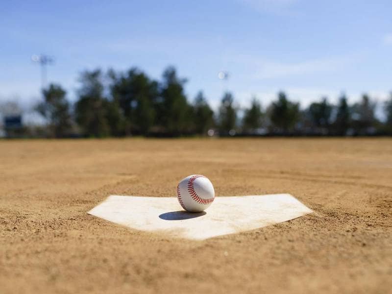 Baseball sitting on home plate.