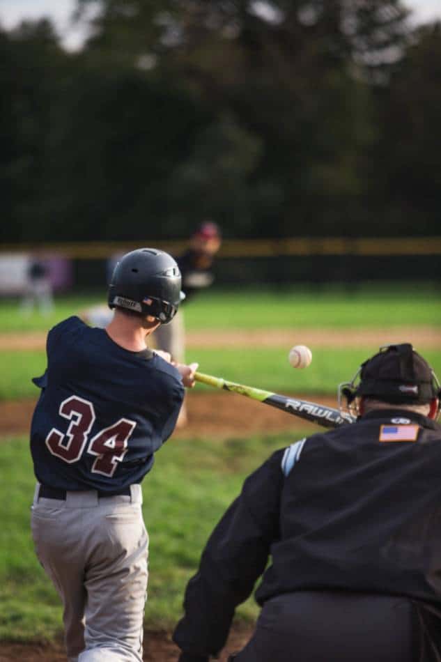 High school baseball player squares up a pitch.