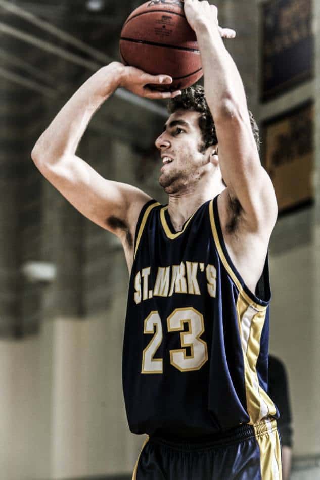 College basketball player in blue and gold takes a jump shot.