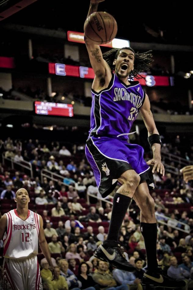 Sacramento Kingsin NBA-pelaaja donkkaa koripallon.