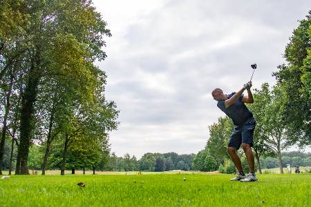 A Golfer prepares to tee off with his driver