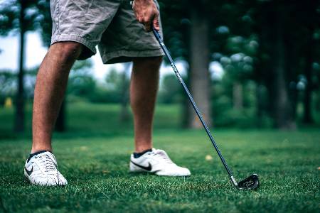 A golfer lines up to tee off on a hole.