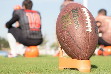 A football sitting on a tee.