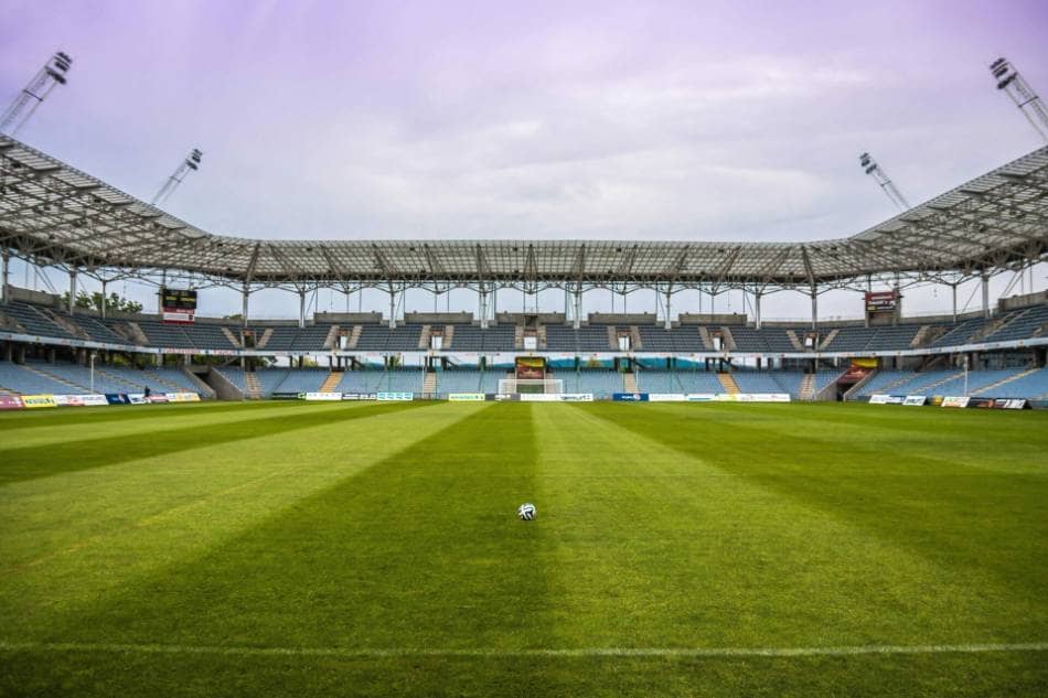 A soccer ball sitting in an empty stadium.