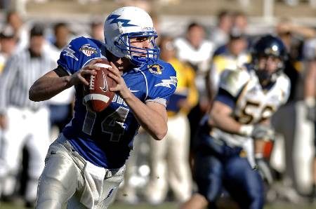 A college quarterback looks to throw the ball.