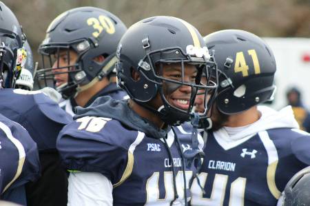 A football player with eye black smiling.