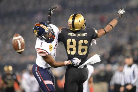 A Navy player holds a West Point player.