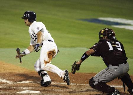 A Rice college baseball player looks at the ball he hits.