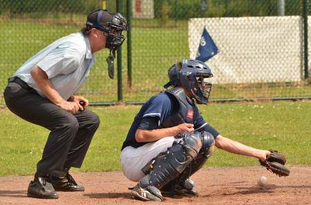 A catcher drops a third strike.