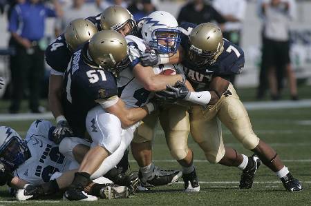 An Air Force receiver gets tackled by four Navy players.