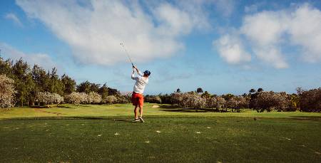 A golfer takes a breakfast ball after his drive.