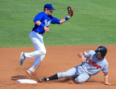 A shortstop makes a catch at second to get the runner out.