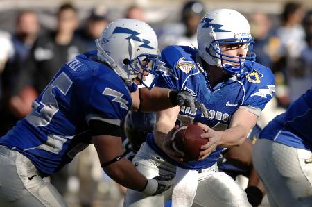 The Air Force QB hands the ball off to the running back during a draw play.