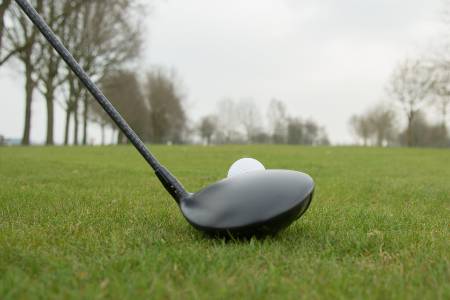 A golfer sets up a neutral face angle with their driver.