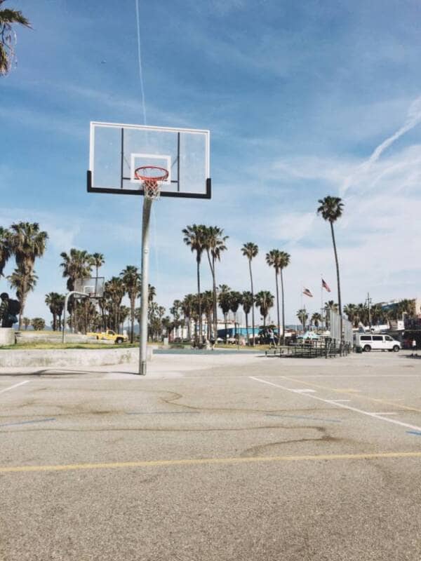 A look from the free throw line on an outdoor basketball court.