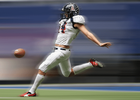 A punter kicking the ball.