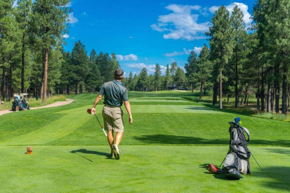 A golfer admiring his tee shot.