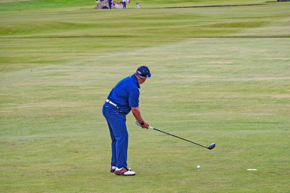 A golfer gets ready to tee off on a hole.