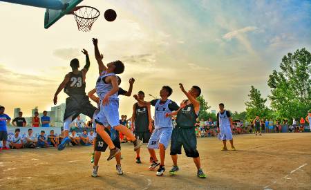 A basketball player drives into the paint for a layup.