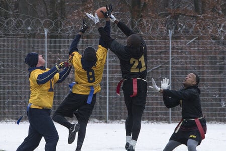 A defensive player earns a pass breakup (PBU) in a game of flag football.