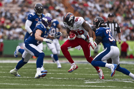 A Broncos player trying to avoid a Vikings and Bears player at the Pro Bowl.