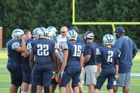 The defensive coordinator talking to the team during a timeout.