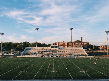 A soccer game taking place on a field with football lines.