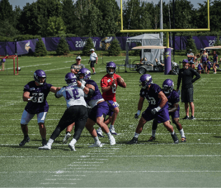 Kirk Cousins drops back for a pass during a scrimmage.