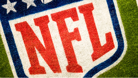 The NFL logo ingrained in a football field.